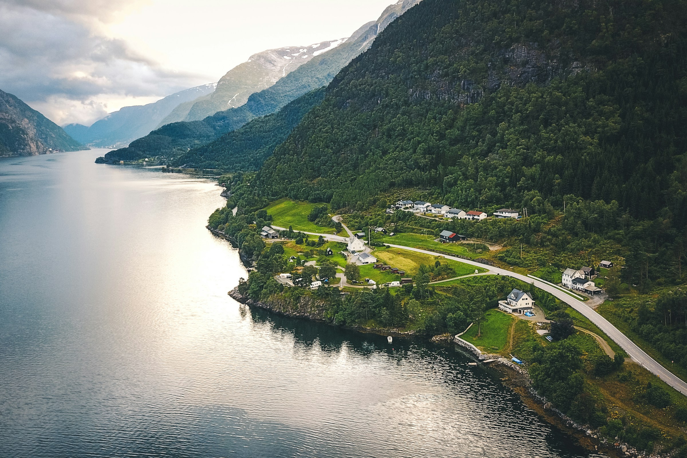 Aerial view of a Norwegian fjord and green mountain slopes